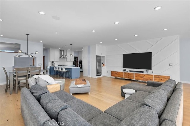 living room featuring light hardwood / wood-style floors and an inviting chandelier