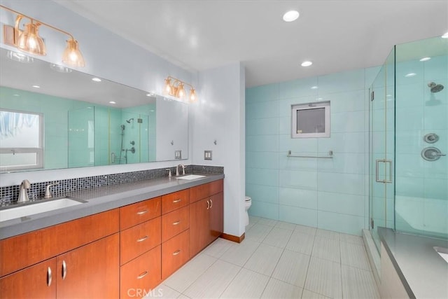 bathroom featuring tile patterned flooring, backsplash, an enclosed shower, toilet, and vanity