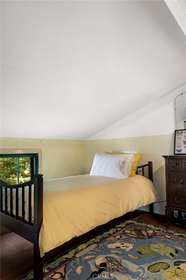 bedroom with hardwood / wood-style flooring and vaulted ceiling