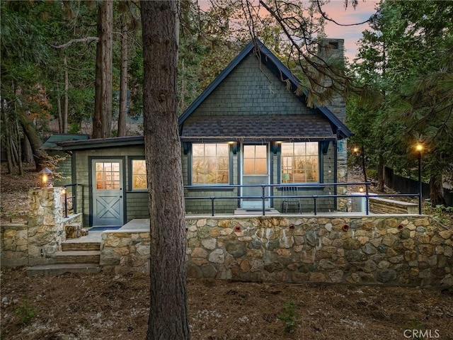 view of back house at dusk