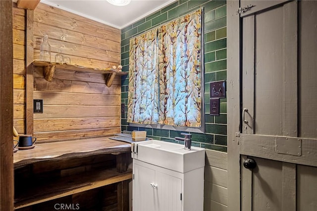 bathroom with sink and tile walls