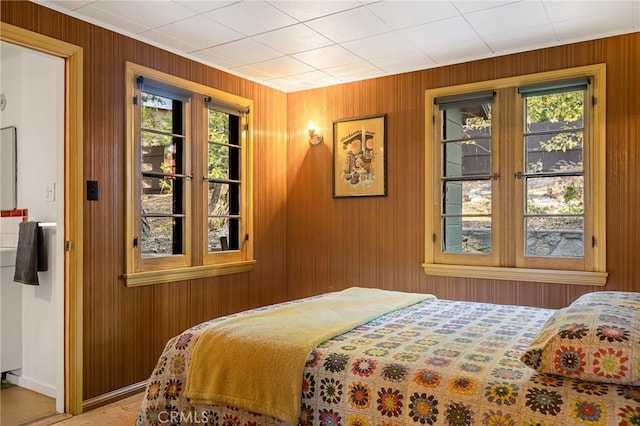 bedroom with wooden walls