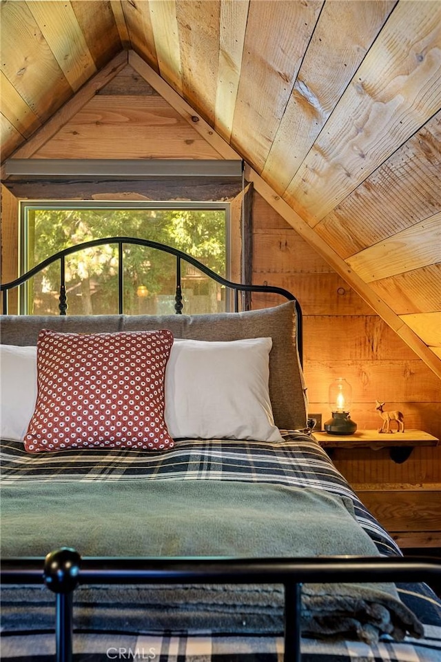 unfurnished bedroom featuring wooden walls, wood ceiling, and lofted ceiling