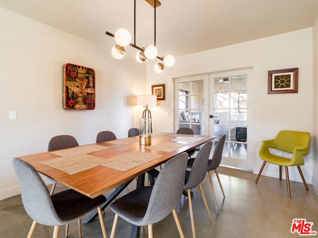 dining area with french doors and concrete flooring