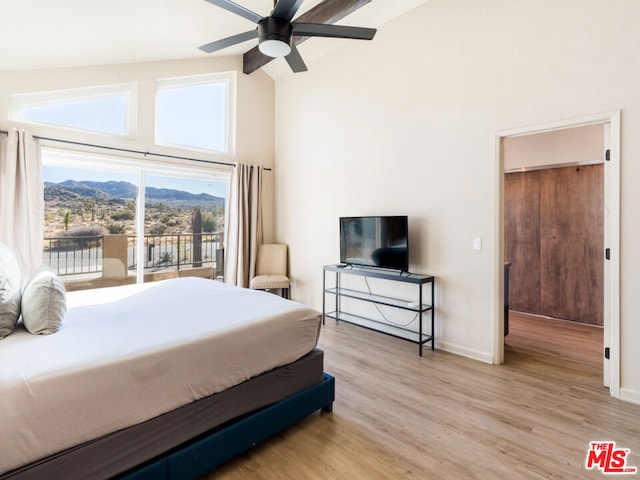 bedroom featuring a mountain view, high vaulted ceiling, ceiling fan, access to exterior, and light hardwood / wood-style floors