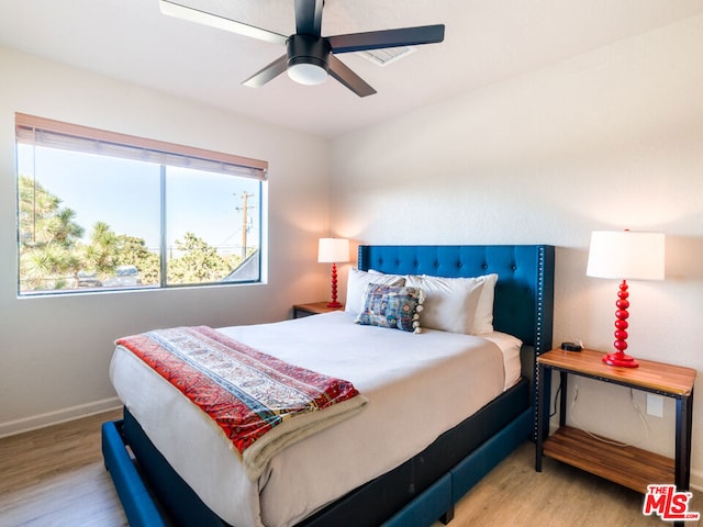 bedroom with ceiling fan and light hardwood / wood-style flooring