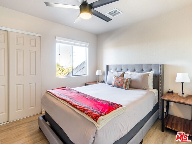 bedroom with light hardwood / wood-style flooring and ceiling fan