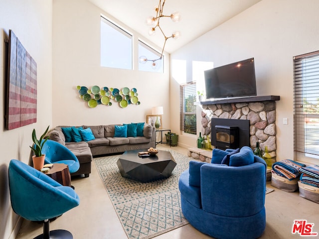 living room with a wood stove, a wealth of natural light, and high vaulted ceiling