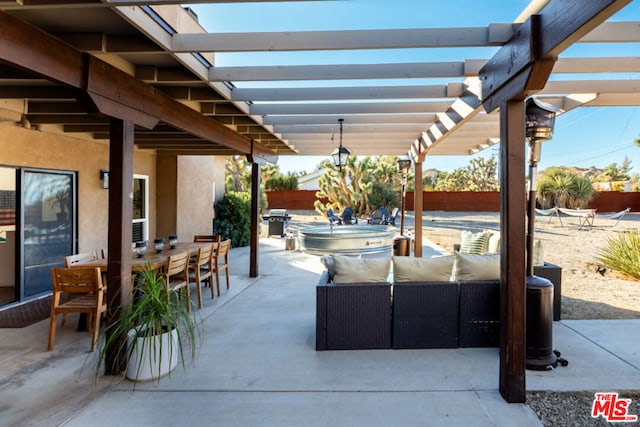 view of patio / terrace featuring a pergola, area for grilling, a bar, and an outdoor hangout area