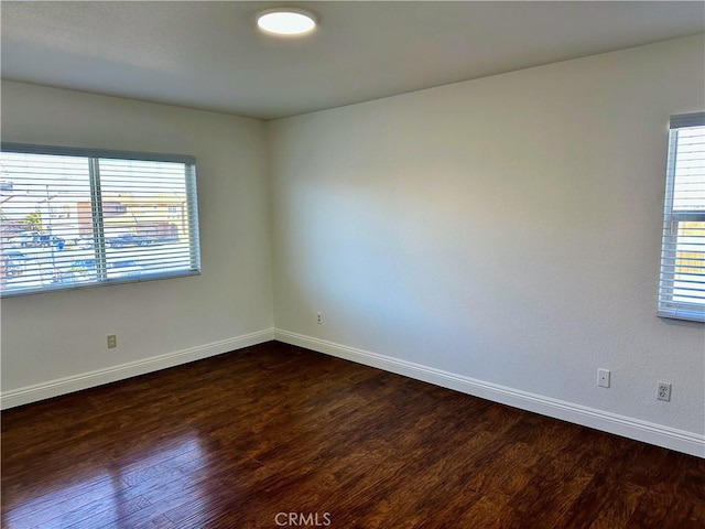 spare room with dark hardwood / wood-style flooring