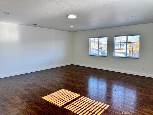 spare room featuring dark wood-type flooring