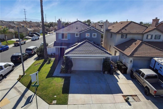 front facade with a front yard and a garage