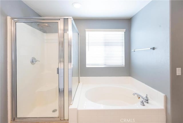 bathroom with shower with separate bathtub