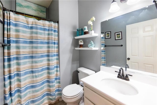 bathroom featuring vanity, a shower with shower curtain, and toilet