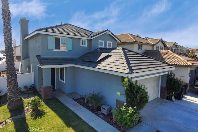 front facade with a front yard and a garage