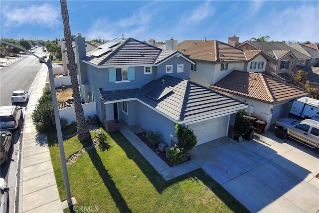 view of front facade with a front yard and a garage