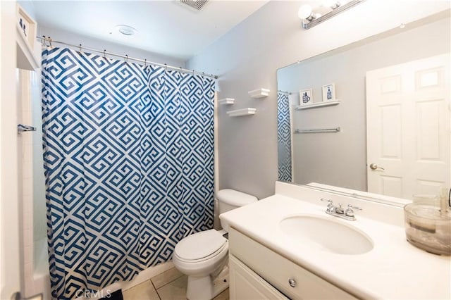 bathroom featuring tile patterned floors, vanity, a shower with shower curtain, and toilet