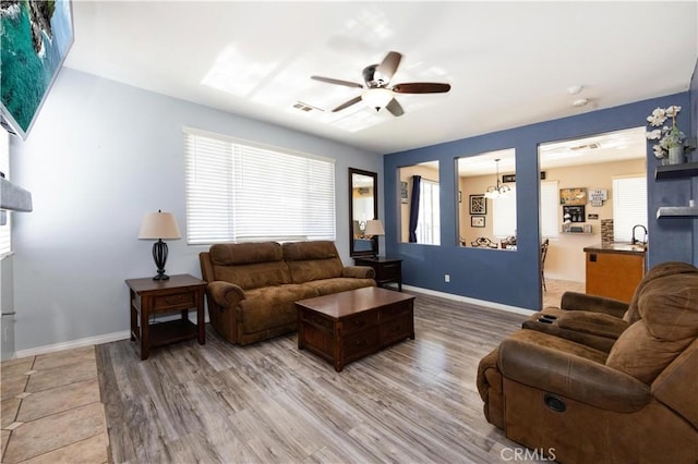 living room with sink, hardwood / wood-style flooring, plenty of natural light, and ceiling fan