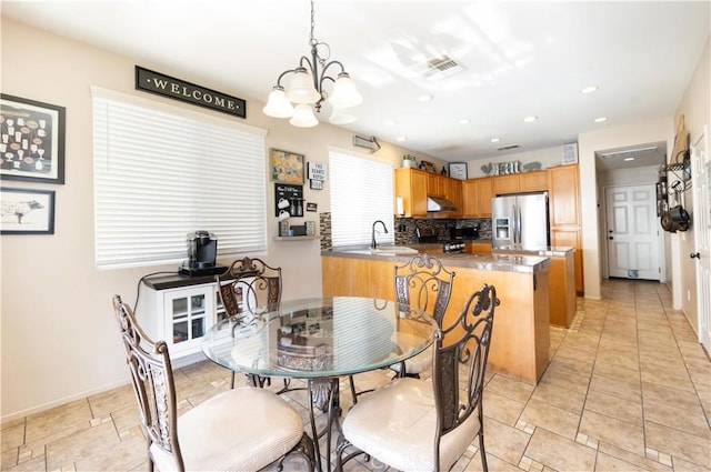 dining room with sink and an inviting chandelier