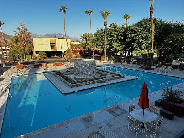 view of pool with a mountain view and a patio