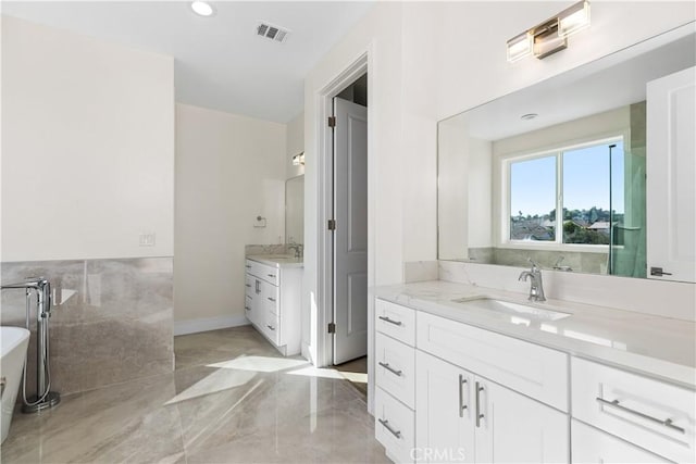 bathroom with a bathing tub and vanity