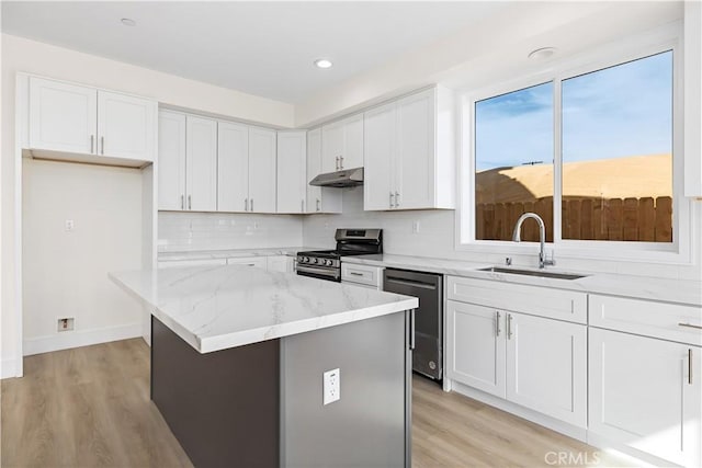 kitchen with white cabinets, a center island, and appliances with stainless steel finishes