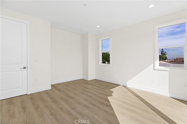 spare room with light wood-type flooring