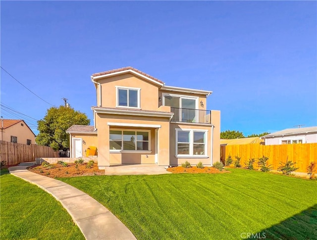 view of front of property featuring a balcony and a front lawn