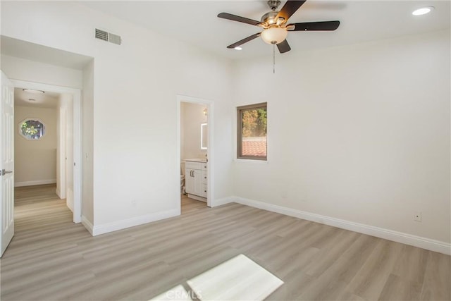 unfurnished bedroom with ensuite bathroom, ceiling fan, and light hardwood / wood-style floors