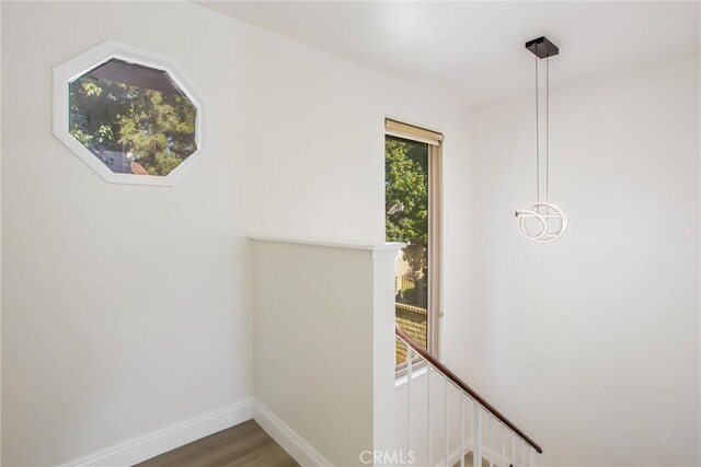 hallway with hardwood / wood-style flooring