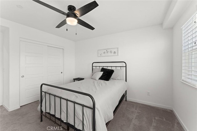 bedroom featuring ceiling fan, a closet, and carpet