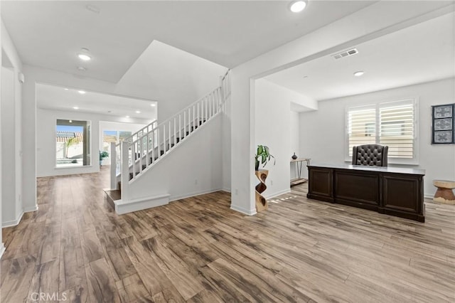 interior space featuring light wood-type flooring and plenty of natural light