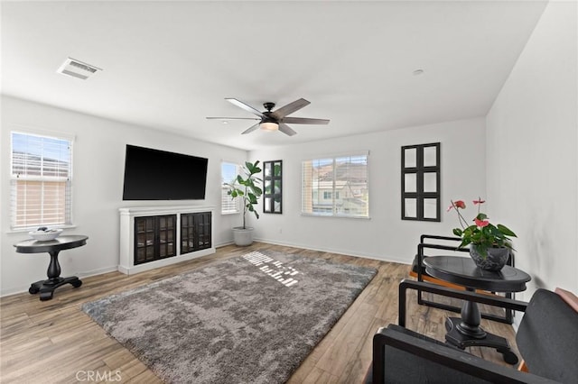 living room featuring ceiling fan and hardwood / wood-style flooring