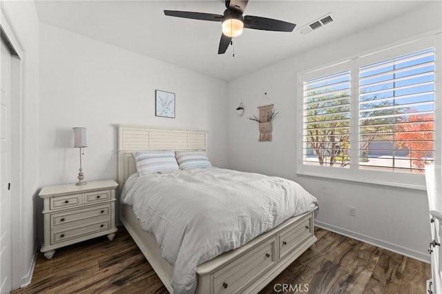 bedroom with ceiling fan and dark wood-type flooring