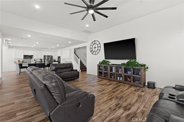 living room featuring ceiling fan and wood-type flooring