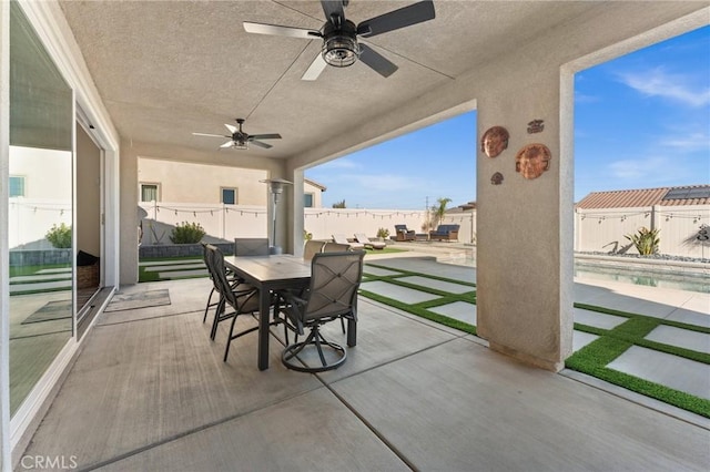 view of patio featuring ceiling fan and a fenced in pool