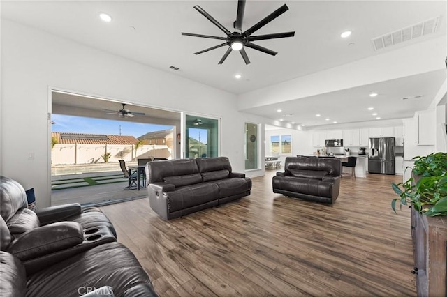 living room featuring hardwood / wood-style floors and ceiling fan