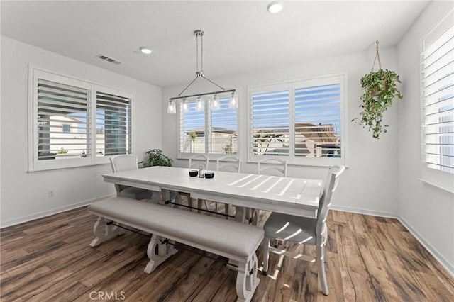 dining room featuring dark wood-type flooring and a notable chandelier