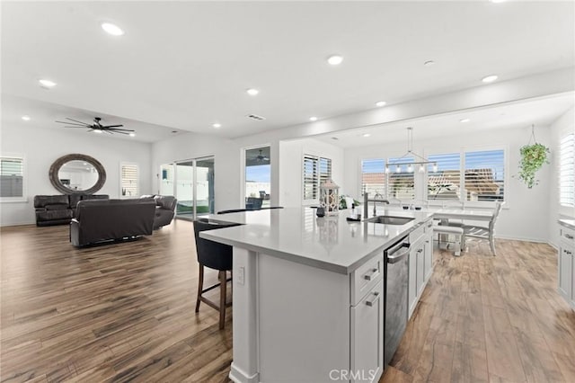 kitchen featuring sink, white cabinetry, a kitchen island with sink, and wood-type flooring