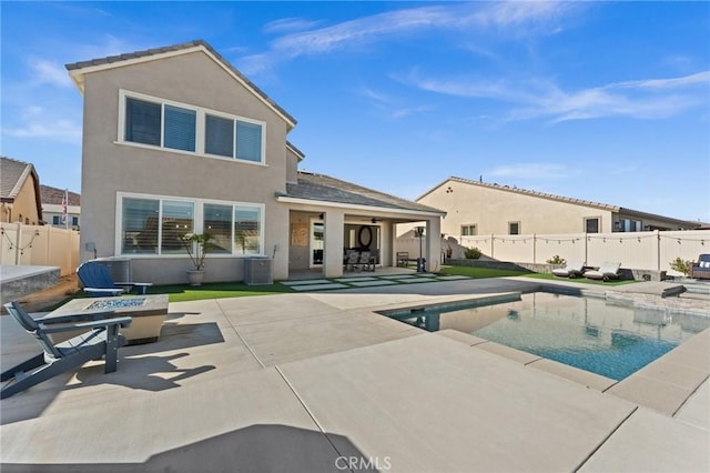 view of pool with a patio, central AC, and an outdoor fire pit