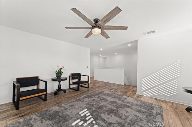 sitting room featuring ceiling fan and wood-type flooring