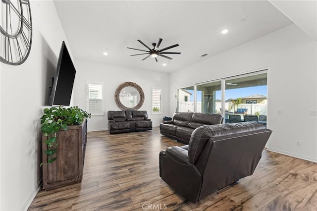 living room featuring ceiling fan and hardwood / wood-style flooring