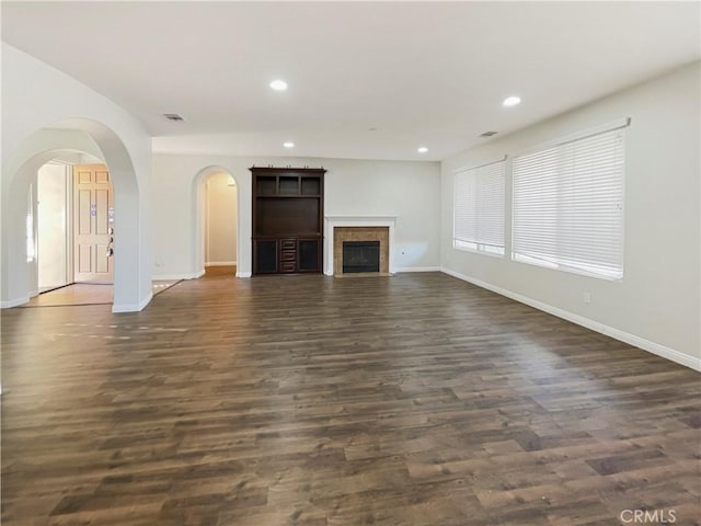 unfurnished living room featuring dark wood-type flooring