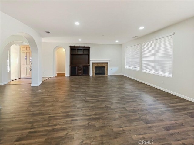 unfurnished living room with dark hardwood / wood-style floors