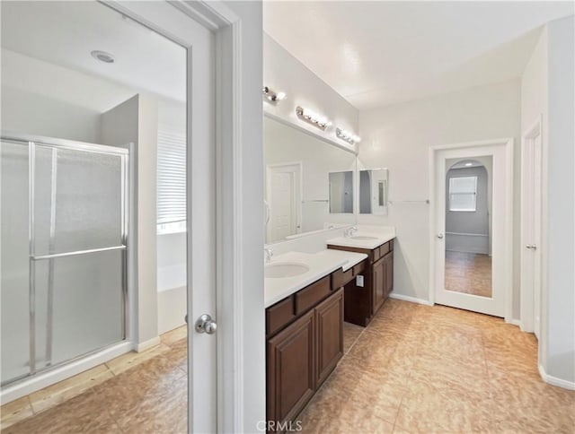 bathroom featuring tile patterned floors, vanity, and a shower with door