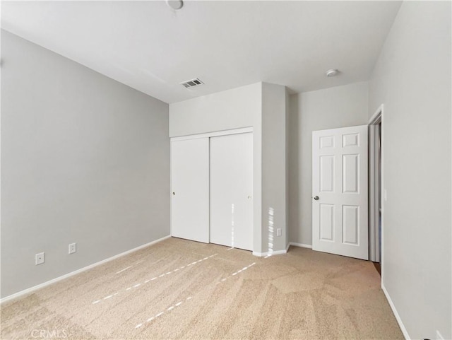 unfurnished bedroom featuring a closet and carpet