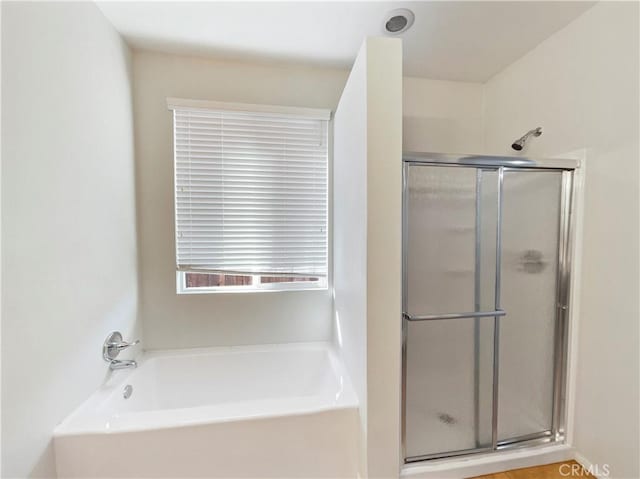 bathroom featuring plus walk in shower