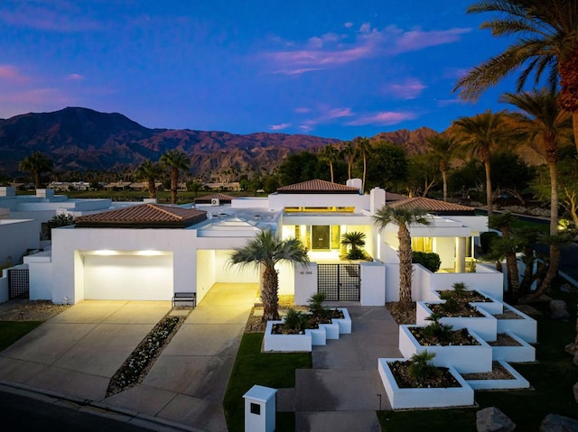 view of front of property featuring a mountain view and a garage