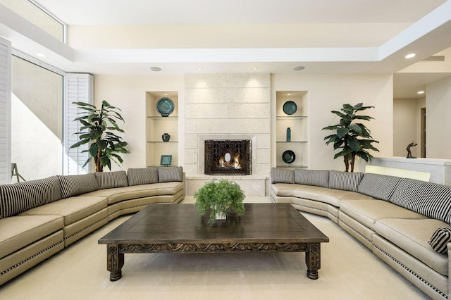 living room featuring a fireplace and built in features