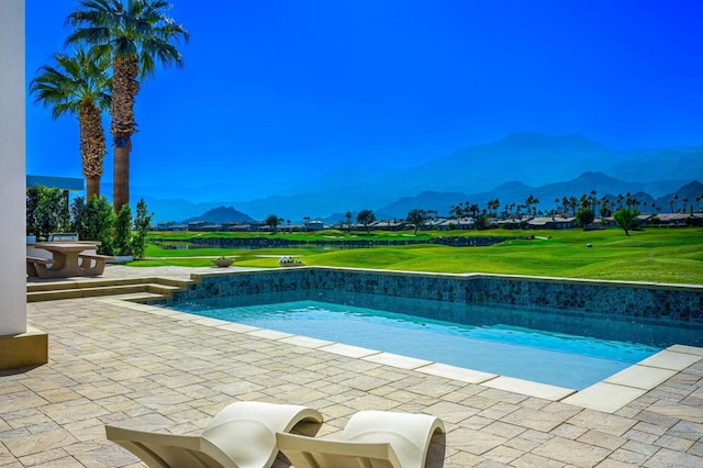 view of swimming pool featuring a mountain view and a patio